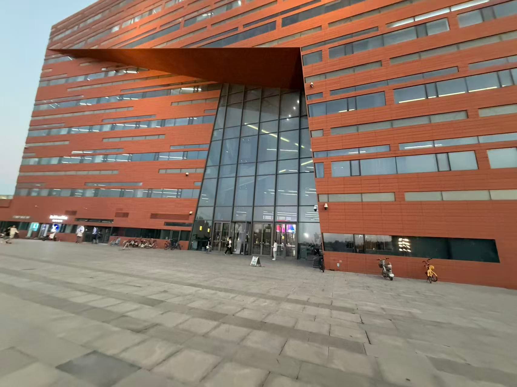 The library's red exterior and entrance plaza