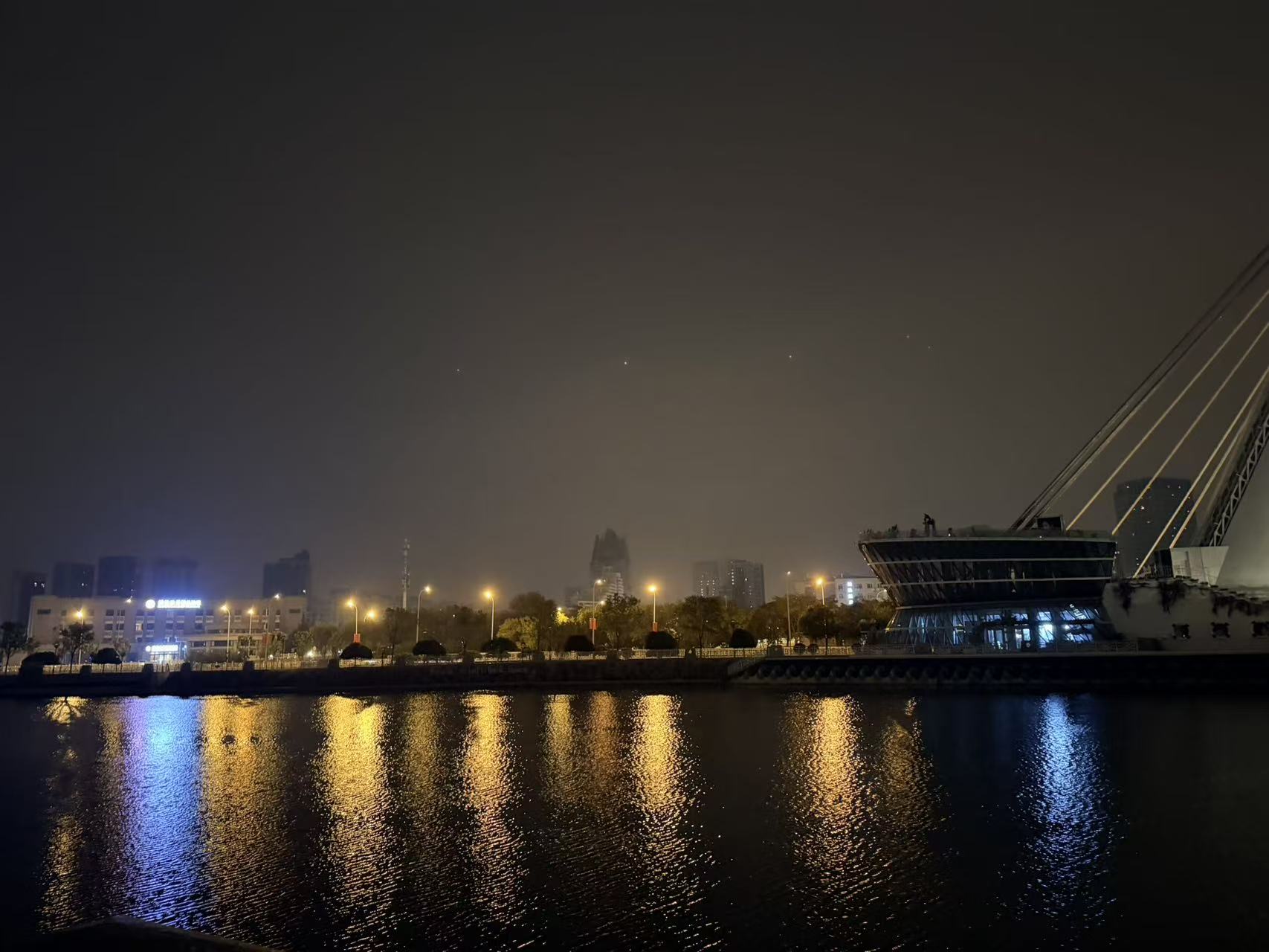 The Haihe River at one in the morning, with sparse lights reflected across the water