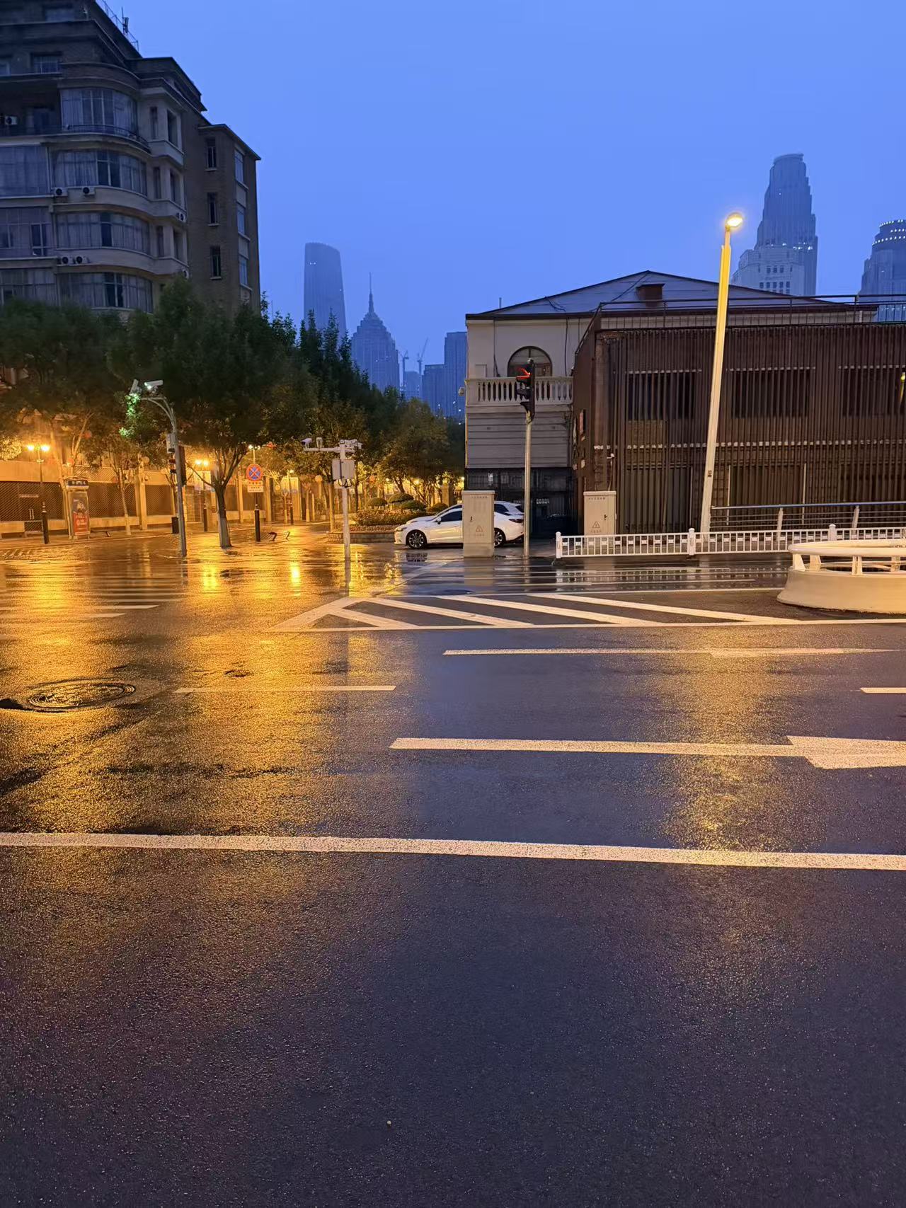 A Tianjin street reflecting the city lights after the rain